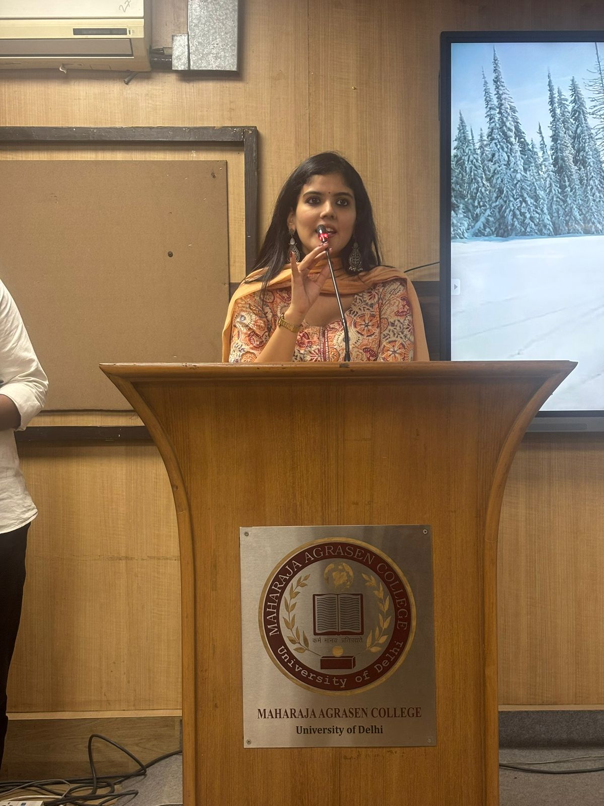 Ankita speaking from a podium